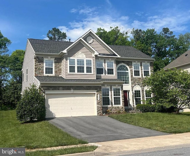 view of front of home with stone siding, driveway, an attached garage, and a front yard