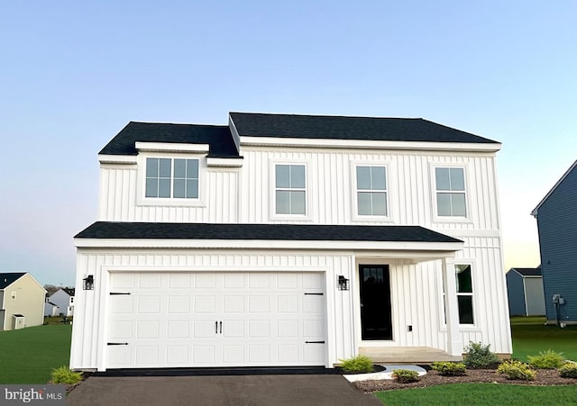 modern inspired farmhouse with board and batten siding, driveway, and a garage
