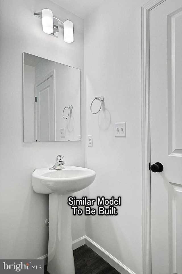 bathroom featuring baseboards and wood finished floors