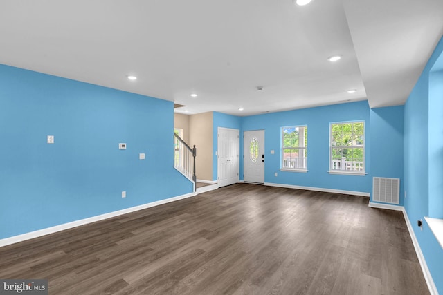 4820 Hayes St NE, Washington, DC 20019 - unfurnished living room featuring stairway, baseboards, recessed lighting, and dark wood-style floors