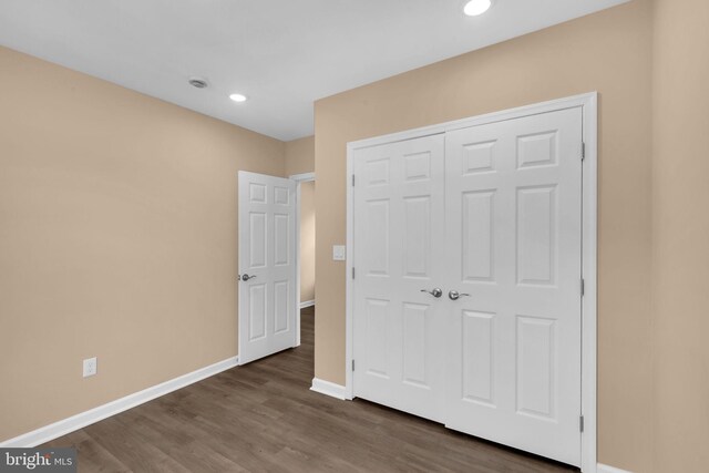 4820 Hayes St NE, Washington, DC 20019 - unfurnished bedroom with baseboards, recessed lighting, dark wood-style floors, and a closet