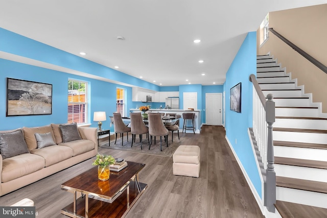 4820 Hayes St NE, Washington, DC 20019 - living area featuring wood finished floors, stairs, baseboards, and recessed lighting