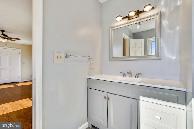 bathroom featuring ceiling fan, vanity, and wood finished floors