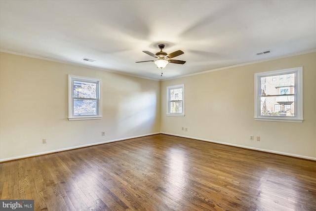 unfurnished room featuring ceiling fan, ornamental molding, wood finished floors, and baseboards