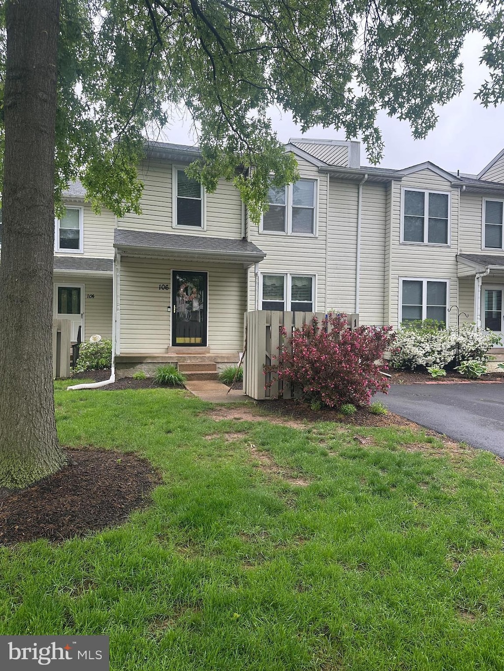 multi unit property with a front lawn and a chimney