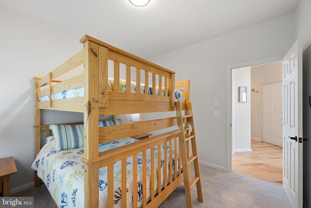bedroom with baseboards and carpet