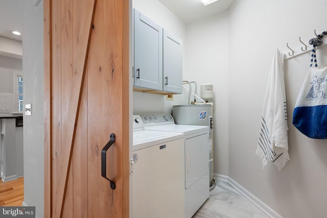 laundry area with cabinet space, washer and clothes dryer, water heater, light marble finish floors, and baseboards