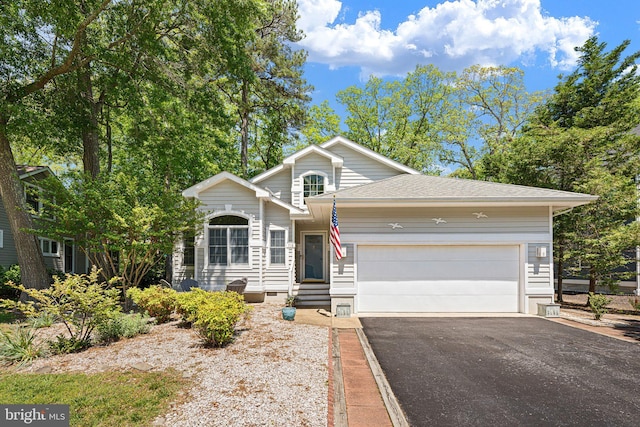 view of front of property featuring asphalt driveway, a garage, crawl space, and roof with shingles