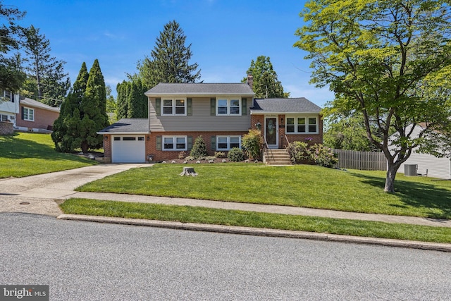 714 Meredith St, Kennett Square, PA 19348 - tri-level home featuring an attached garage, concrete driveway, and brick siding
