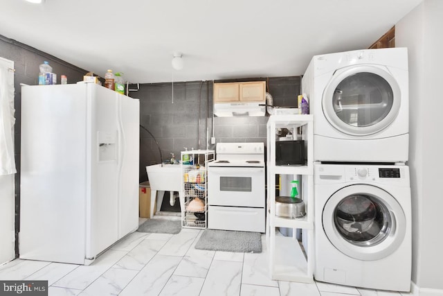 washroom with estacked washer and dryer, light marble finish floors, and a sink