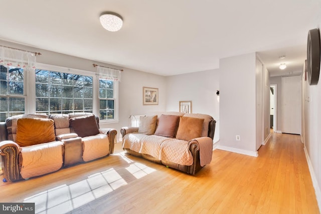 living room featuring light wood-style flooring and baseboards