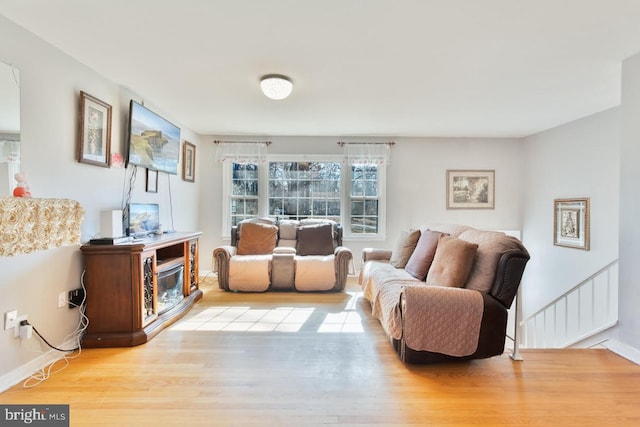 living room with wood finished floors and baseboards
