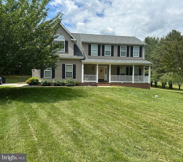 6510 Christmas Tree Ln, Huntingtown, MD 20639 - colonial inspired home with a porch and a front yard