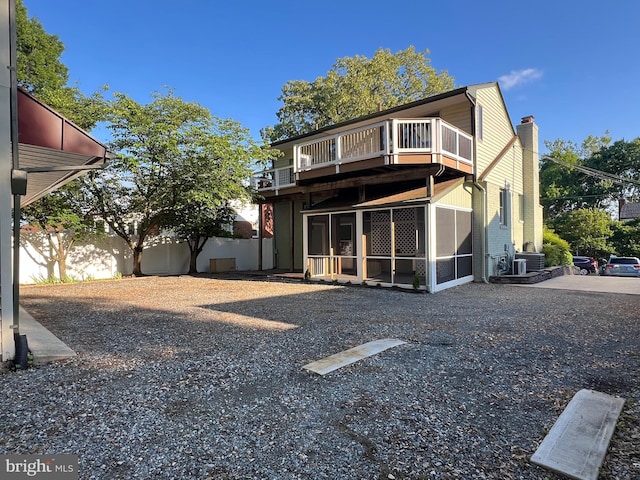 8107 Chester St, Takoma Park, MD 20912 - rear view of property featuring a balcony, a sunroom, and a chimney