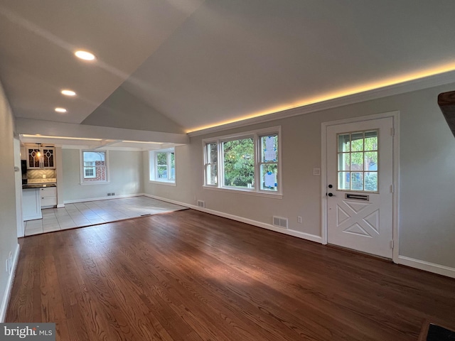 8107 Chester St, Takoma Park, MD 20912 - unfurnished living room with healthy amount of natural light, wood finished floors, baseboards, recessed lighting, and lofted ceiling
