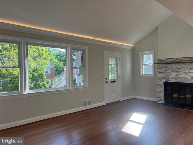 8107 Chester St, Takoma Park, MD 20912 - unfurnished living room with wood finished floors, baseboards, vaulted ceiling, and a stone fireplace