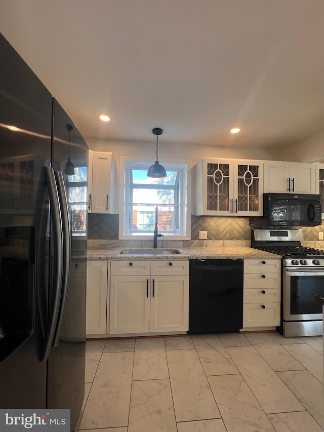 8107 Chester St, Takoma Park, MD 20912 - kitchen with black appliances, a sink, white cabinets, backsplash, and recessed lighting