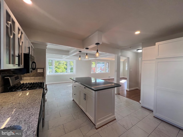 8107 Chester St, Takoma Park, MD 20912 - kitchen with stainless steel range with gas stovetop, recessed lighting, baseboards, white cabinets, and a kitchen island