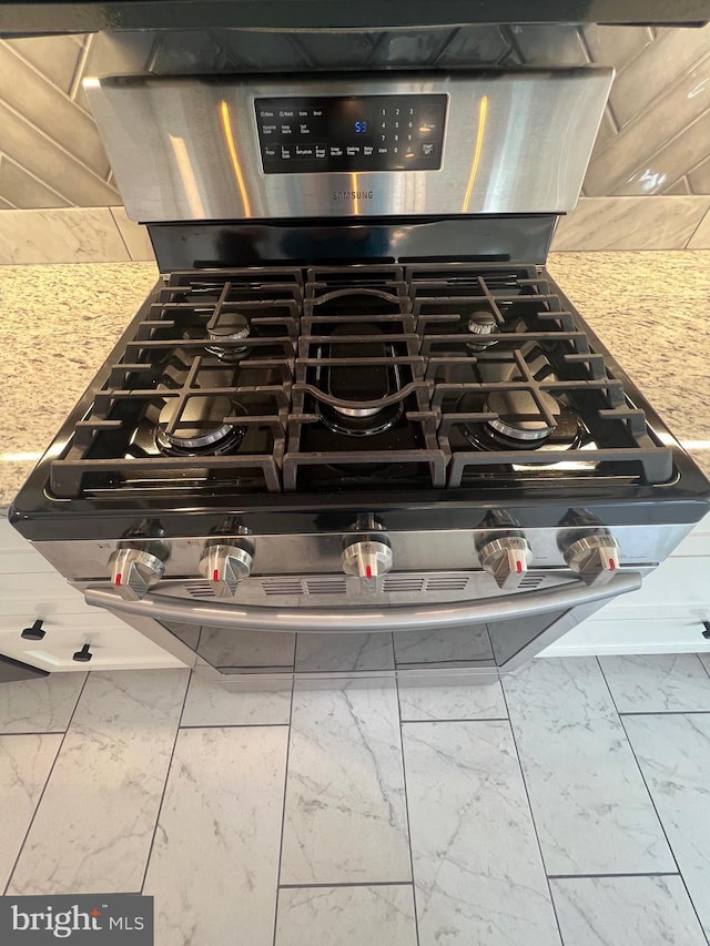 8107 Chester St, Takoma Park, MD 20912 - kitchen view of stainless steel gas range oven and tasteful backsplash