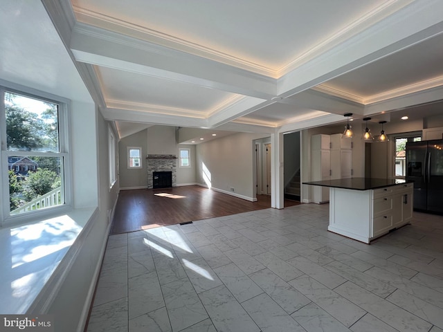 8107 Chester St, Takoma Park, MD 20912 - unfurnished living room with stairs, plenty of natural light, a stone fireplace, crown molding, and beamed ceiling