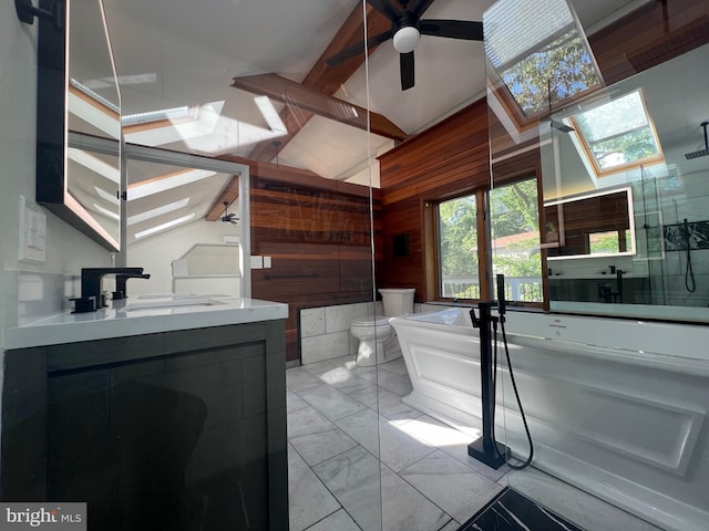 8107 Chester St, Takoma Park, MD 20912 - full bathroom with wood walls, a freestanding bath, vanity, a ceiling fan, and marble look tiles