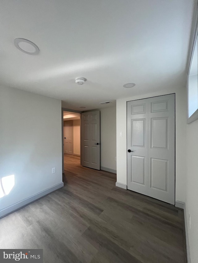 8107 Chester St, Takoma Park, MD 20912 - spare room featuring wood finished floors, baseboards, and a smoke detector