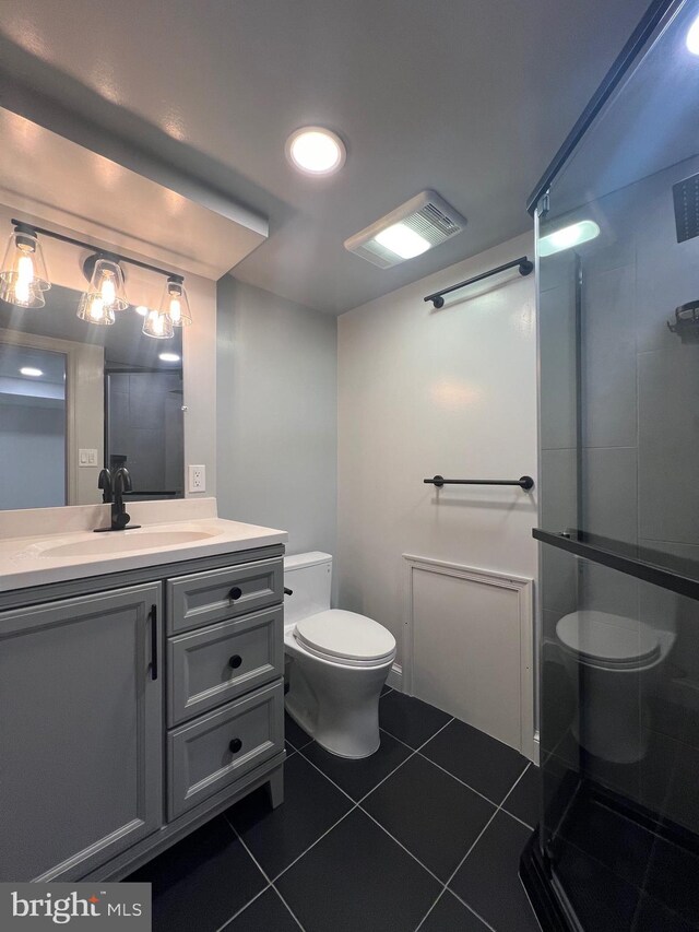 8107 Chester St, Takoma Park, MD 20912 - bathroom with toilet, tile patterned flooring, a shower stall, and vanity