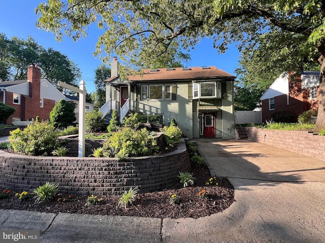 8107 Chester St, Takoma Park, MD 20912 - view of front facade featuring driveway and a chimney