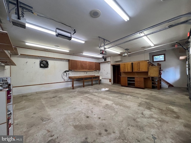8107 Chester St, Takoma Park, MD 20912 - garage with a garage door opener and a workshop area
