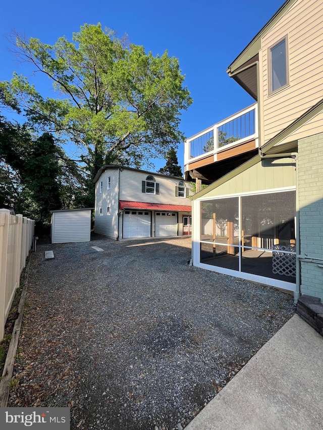 8107 Chester St, Takoma Park, MD 20912 - view of yard featuring a balcony, an outdoor structure, a sunroom, and fence