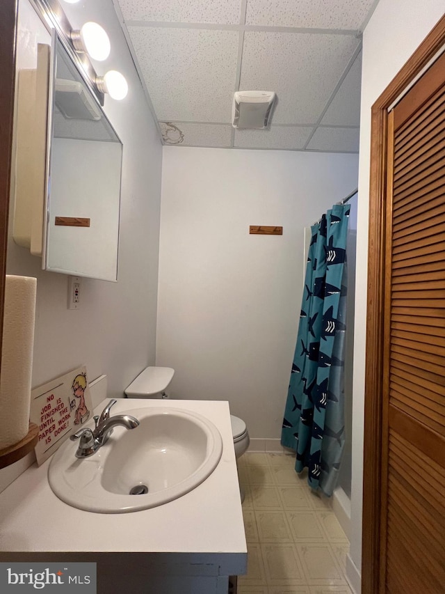 8107 Chester St, Takoma Park, MD 20912 - full bath with a paneled ceiling, toilet, tile patterned floors, vanity, and a shower with curtain