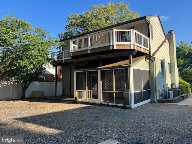 8107 Chester St, Takoma Park, MD 20912 - back of house featuring a balcony, a sunroom, and brick siding