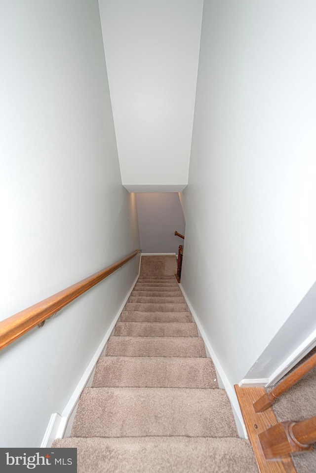 staircase featuring baseboards