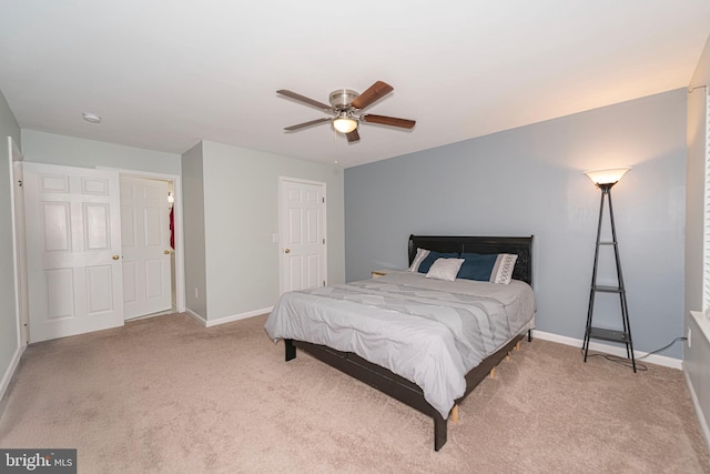 bedroom featuring light carpet, baseboards, and a ceiling fan