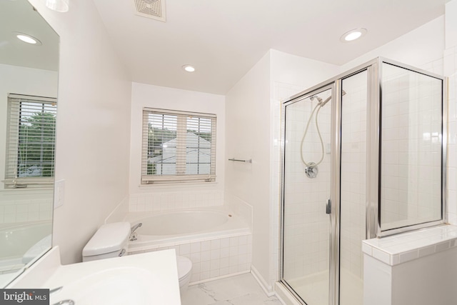 full bath with a shower stall, marble finish flooring, a garden tub, toilet, and recessed lighting