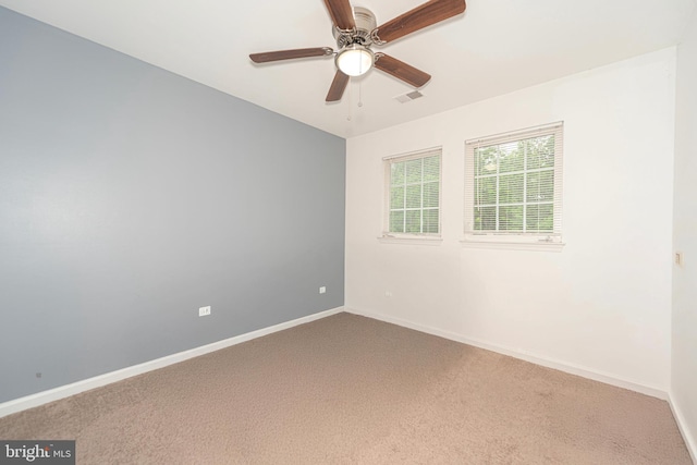 unfurnished room with carpet, a ceiling fan, and baseboards