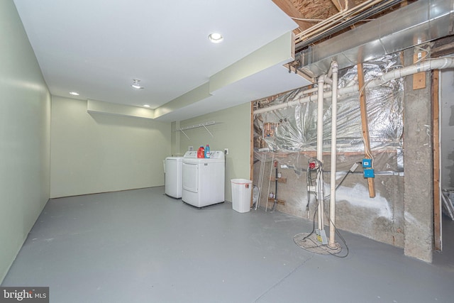 unfinished basement with washing machine and clothes dryer and recessed lighting