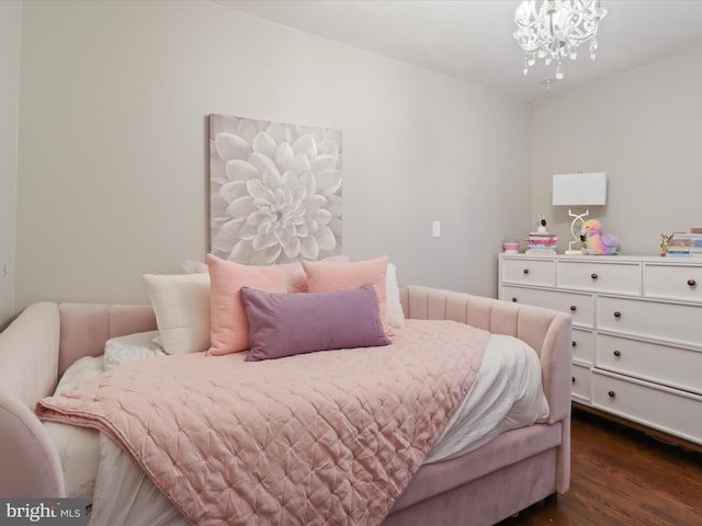 bedroom with dark wood-type flooring and a chandelier