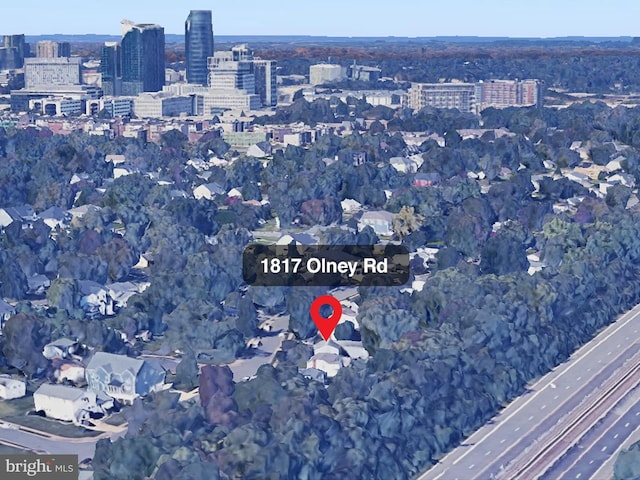 aerial view of property's location with nearby urban area