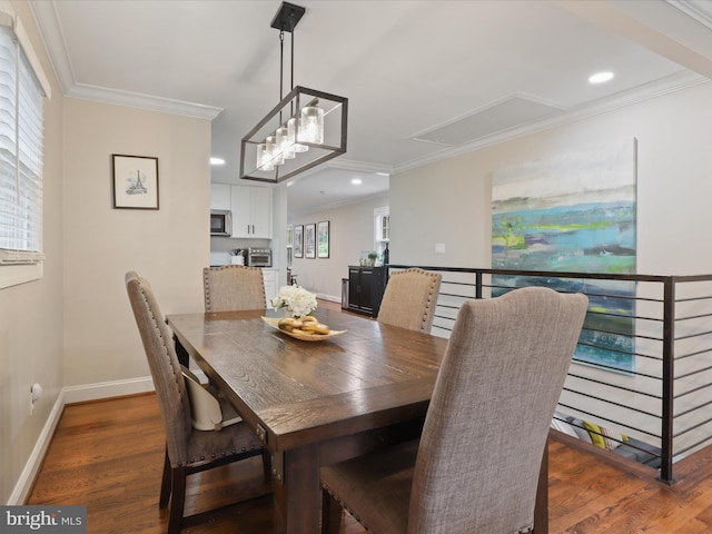 dining room with attic access, ornamental molding, wood finished floors, baseboards, and recessed lighting
