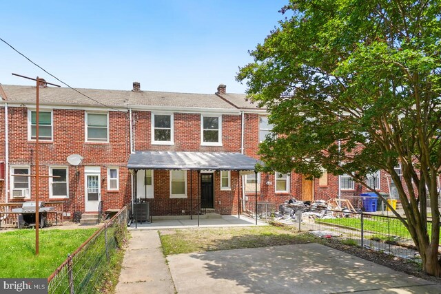 3505 Erdman Ave, Baltimore, MD 21213 - view of front of property featuring a chimney, brick siding, and central air condition unit