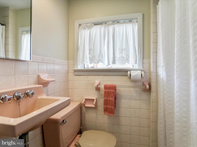 629 W Piedmont St, Keyser, WV 26726 - bathroom with tile walls, a sink, wainscoting, toilet, and a shower with curtain