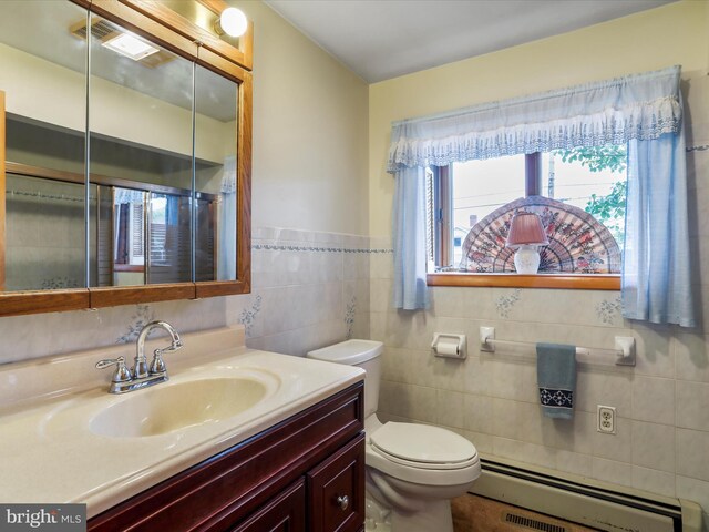 629 W Piedmont St, Keyser, WV 26726 - bathroom with a baseboard heating unit, toilet, vanity, and tile walls