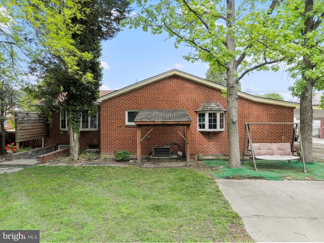 629 W Piedmont St, Keyser, WV 26726 - rear view of property featuring a yard, brick siding, and central air condition unit