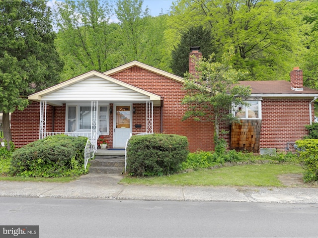 629 W Piedmont St, Keyser, WV 26726 - view of front facade featuring a chimney and brick siding