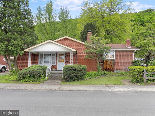 629 W Piedmont St, Keyser, WV 26726 - view of front of home with a chimney, covered porch, and brick siding