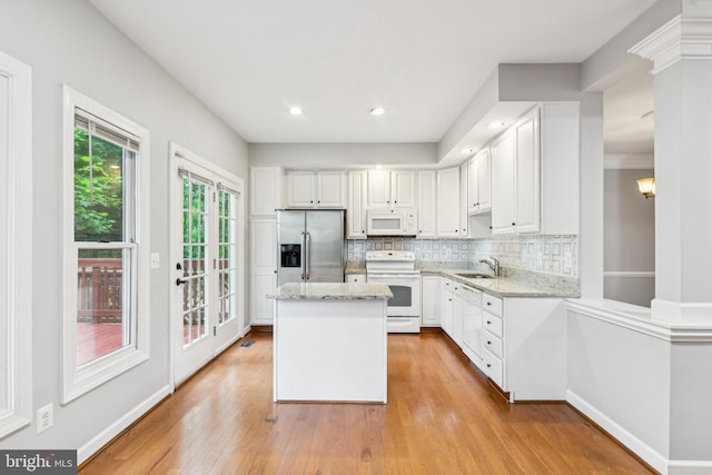 7702 Ousley Pl, Alexandria, VA 22315 - kitchen with white appliances, white cabinetry, tasteful backsplash, light stone counters, and recessed lighting