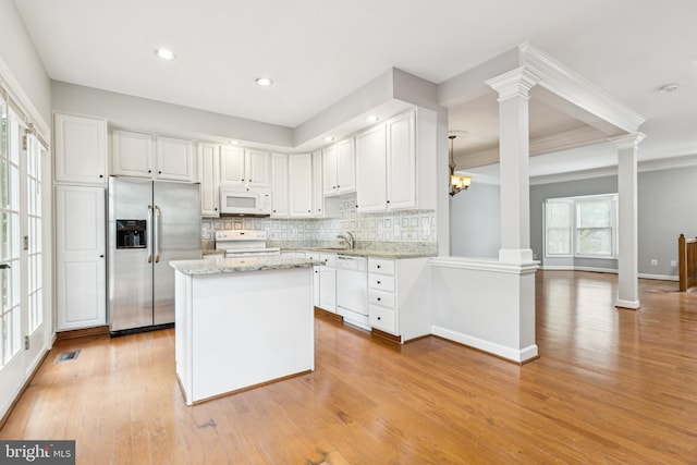 7702 Ousley Pl, Alexandria, VA 22315 - kitchen with white appliances, ornate columns, tasteful backsplash, white cabinetry, and ornamental molding