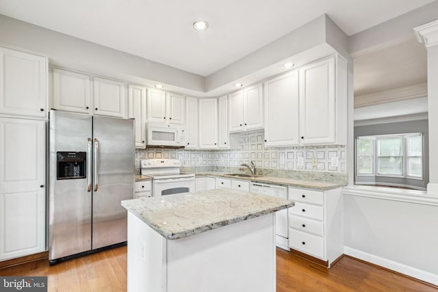 7702 Ousley Pl, Alexandria, VA 22315 - kitchen featuring white appliances, light wood-style floors, white cabinets, and recessed lighting