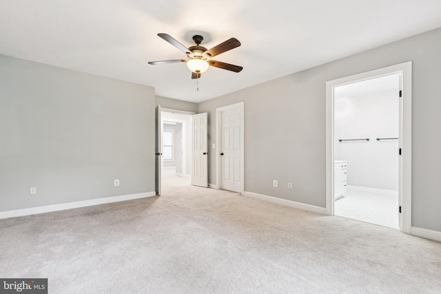 7702 Ousley Pl, Alexandria, VA 22315 - unfurnished bedroom featuring light carpet, ensuite bathroom, and ceiling fan